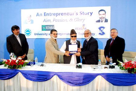 Mian Bashir Ahmed, Co-founder Sitara Group of Industries, receives souvenir from Dr A R Kausar, Pro-Rector UMT
